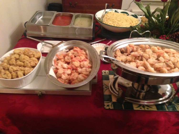 In the foreground, fried shrimp and fried cauliflower. In the background, pasta with clam sauce (and a tomato sauce alternative for the various picky eaters the family has absorbed along the way.