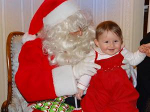 Viola and Santa in 2013, with a reassuring hand from her dad.