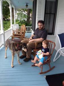 Even at one, my granddaughter understood the joy of reading on the porch.