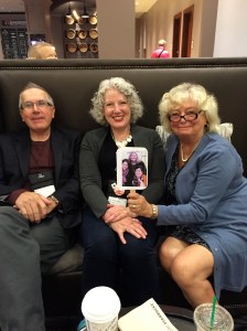 Ray Daniel, Julie Hennrikus, and Michele Dorsey holding a photo of the Wickeds who couldn't make it to Bouchercon.