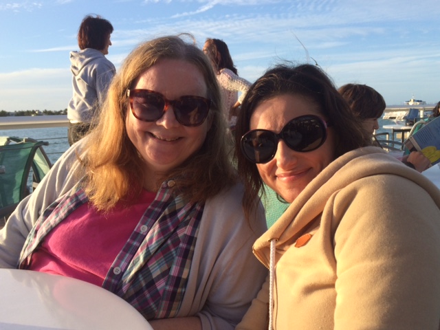 Barb and Liz drinking a margarita and mojito (respectively) on Mallory Pier at sunset, Key West